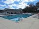 Outdoor swimming pool with lounge chairs, poolside community building and well-kept decking for relaxation at 3142 Silvermines Ave, Ormond Beach, FL 32174