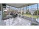 Relaxing screened porch with tiled flooring and outdoor seating at 41 Laurel Oaks Cir, Ormond Beach, FL 32174