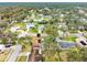 Aerial view of a home with solar panels and a pool surrounded by a lush landscape at 812 Whiporwill Dr, Port Orange, FL 32127