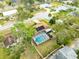 Aerial view of a home showcasing its solar panels, screened pool, and well-maintained lawn at 812 Whiporwill Dr, Port Orange, FL 32127