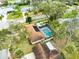 Aerial view of home with solar panels, screened pool, and mature trees at 812 Whiporwill Dr, Port Orange, FL 32127