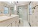 Well-lit bathroom with a shower and tub features a large vanity and plenty of storage at 812 Whiporwill Dr, Port Orange, FL 32127