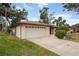 Charming single-story home featuring a two-car garage and manicured lawn at 812 Whiporwill Dr, Port Orange, FL 32127