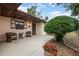 Inviting front porch with seating area, lush landscaping and a decorative front door at 812 Whiporwill Dr, Port Orange, FL 32127