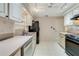 Bright kitchen features stainless steel appliances and white cabinets at 812 Whiporwill Dr, Port Orange, FL 32127