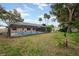 Private screened pool and patio with yard and tropical landscaping create a private, peaceful oasis at 812 Whiporwill Dr, Port Orange, FL 32127