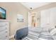 Relaxing bedroom with nautical decor, wood flooring, and an adjacent bathroom at 820 Aldenham Ln, Ormond Beach, FL 32174