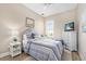 Comfortable bedroom with a large bed and stylish, coastal decor, including an updated ceiling fan at 820 Aldenham Ln, Ormond Beach, FL 32174