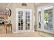 Inviting entryway featuring tile floors and double doors to the living room and exterior at 820 Aldenham Ln, Ormond Beach, FL 32174