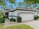 Charming home featuring a 2-car garage, well-maintained landscaping, and a beautiful stone facade at 820 Aldenham Ln, Ormond Beach, FL 32174