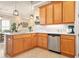 Open kitchen featuring stainless steel appliances, tile backsplash, and wooden cabinetry with ample storage space at 820 Aldenham Ln, Ormond Beach, FL 32174