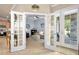 Inviting living room featuring french doors, light blue walls, and cozy furniture at 820 Aldenham Ln, Ormond Beach, FL 32174