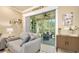Living room featuring sliding doors that lead to the screened porch and bring natural light into the home at 820 Aldenham Ln, Ormond Beach, FL 32174