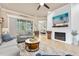 Comfortable living room features a shiplap accent wall with fireplace and backyard view at 820 Aldenham Ln, Ormond Beach, FL 32174