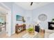 Living room with light blue walls, TV, console table with decor and comfortable seating at 820 Aldenham Ln, Ormond Beach, FL 32174