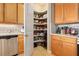 Pantry with organized shelving and wood cabinets at 820 Aldenham Ln, Ormond Beach, FL 32174