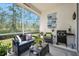 Relaxing screened porch with a grill and outdoor furniture with a view of the yard at 820 Aldenham Ln, Ormond Beach, FL 32174