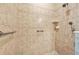Spacious tiled shower with grab bar, a shower head, and a hand-held shower fixture for accessibility at 820 Aldenham Ln, Ormond Beach, FL 32174
