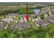 Aerial view showcasing the townhome's location within a quiet community with a lake at 830 Aldenham Ln, Ormond Beach, FL 32174