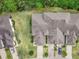 Aerial view of a townhome community showing building layout and landscaping at 830 Aldenham Ln, Ormond Beach, FL 32174