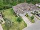 Two-story house with gray roof and brick paver driveway, surrounded by lush landscaping at 830 Aldenham Ln, Ormond Beach, FL 32174