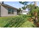 Home with a spacious backyard, lush landscaping, and screened patio at 830 Aldenham Ln, Ormond Beach, FL 32174