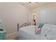 Cozy bedroom with a metal bed frame and en-suite bathroom at 830 Aldenham Ln, Ormond Beach, FL 32174