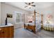 Cozy bedroom with a four-poster bed and plenty of natural light at 830 Aldenham Ln, Ormond Beach, FL 32174