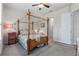 Charming bedroom with a four-poster bed and access to bathroom at 830 Aldenham Ln, Ormond Beach, FL 32174