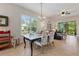 Open concept dining room with large table and chairs, adjacent to living room at 830 Aldenham Ln, Ormond Beach, FL 32174