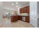 Open concept kitchen with wood cabinets, granite countertops and stainless steel appliances at 830 Aldenham Ln, Ormond Beach, FL 32174
