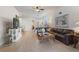 Spacious living room with tile floors, comfortable seating, and a view into the dining area at 830 Aldenham Ln, Ormond Beach, FL 32174