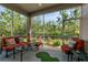 Relaxing screened porch with seating and views of nature at 830 Aldenham Ln, Ormond Beach, FL 32174