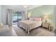 Bright bedroom with king-size bed and access to patio at 135 Lagoon Ct, New Smyrna Beach, FL 32169