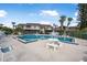 Relaxing community pool with lounge chairs and patio furniture at 135 Lagoon Ct, New Smyrna Beach, FL 32169