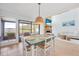 Bright dining area with light teal table and waterfront view at 135 Lagoon Ct, New Smyrna Beach, FL 32169