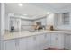 Gray kitchen cabinets, stainless steel appliances, and granite countertops at 135 Lagoon Ct, New Smyrna Beach, FL 32169