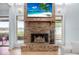 Brick fireplace with water view, creating a cozy living space at 135 Lagoon Ct, New Smyrna Beach, FL 32169