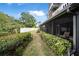 Landscaped pathway leading to the backyard and patio at 135 Lagoon Ct, New Smyrna Beach, FL 32169