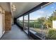 Waterfront screened porch with ceiling fan and rocking chairs at 135 Lagoon Ct, New Smyrna Beach, FL 32169