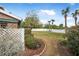 Landscaped side yard with a white fence at 135 Lagoon Ct, New Smyrna Beach, FL 32169