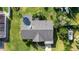 An aerial shot captures the layout of the roof, driveway and lush green landscaping of the property at 188 Benjamin Dr, Ormond Beach, FL 32176