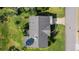 An aerial shot captures the layout of the roof, driveway and lush green landscaping of the property at 188 Benjamin Dr, Ormond Beach, FL 32176