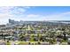 This aerial view captures the vast residential area with its neat rows of houses, close proximity to the coast, and city on horizon at 188 Benjamin Dr, Ormond Beach, FL 32176