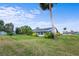 View of a large backyard with lush green grass and mature trees under a sunny sky at 188 Benjamin Dr, Ormond Beach, FL 32176