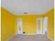 Bright yellow bedroom with tile floors, closet storage, and bright lighting at 188 Benjamin Dr, Ormond Beach, FL 32176