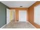 Empty bedroom with a closet, neutral tile flooring, and two entry doors leading to other parts of the home at 188 Benjamin Dr, Ormond Beach, FL 32176