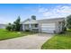 Single-story home with white brick, one-car garage, well-kept lawn, and simple landscaping offers comfortable curb appeal at 188 Benjamin Dr, Ormond Beach, FL 32176