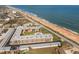 Aerial of condo complex featuring beach proximity and inviting courtyard pool area at 2100 Ocean Shore Blvd # 1150, Ormond Beach, FL 32176