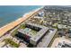 Aerial view of a condo complex near the beach with pool, highlighted with a red arrow at 2100 Ocean Shore Blvd # 1150, Ormond Beach, FL 32176